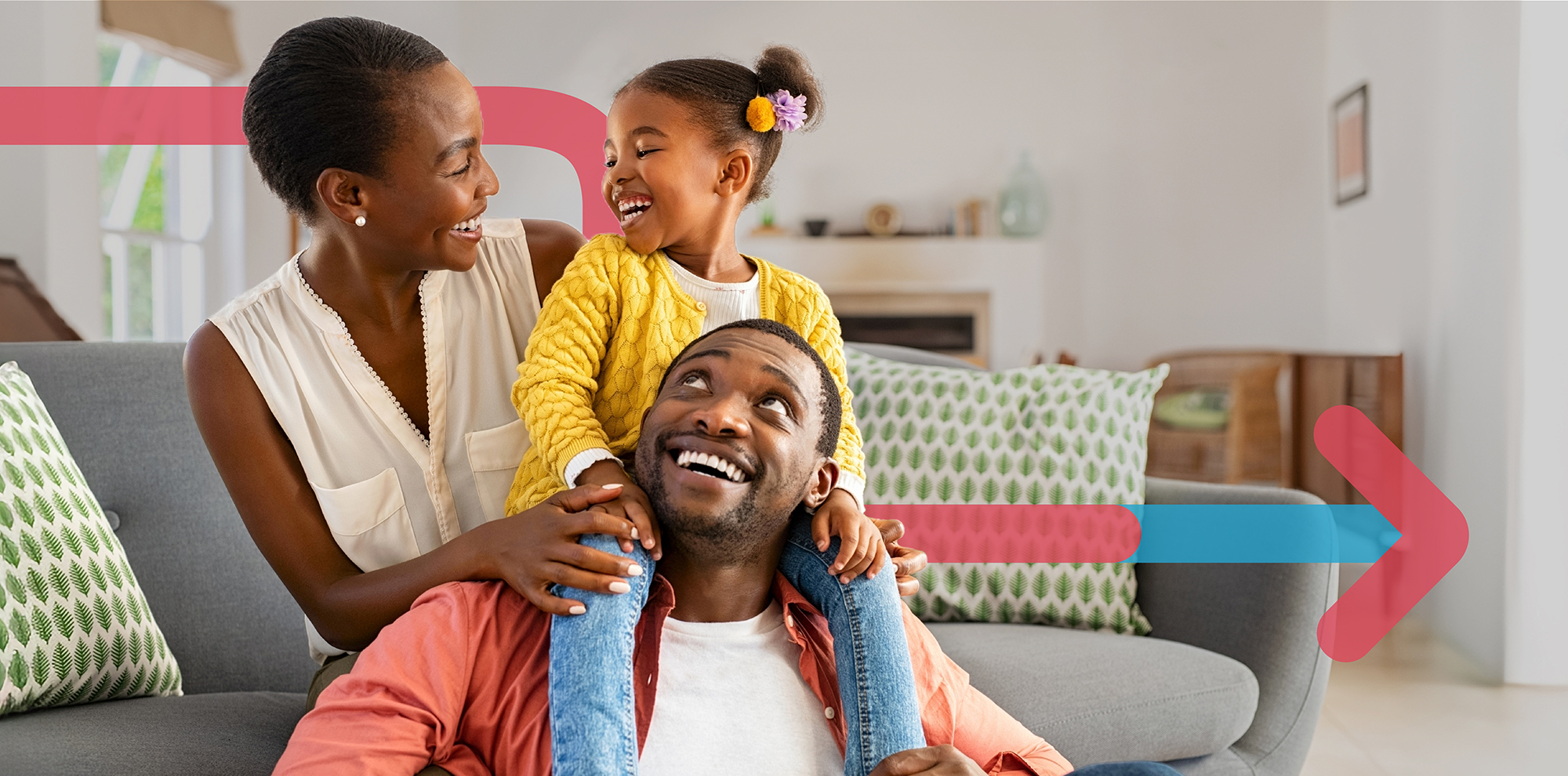 A smiling family playing with their young daughter